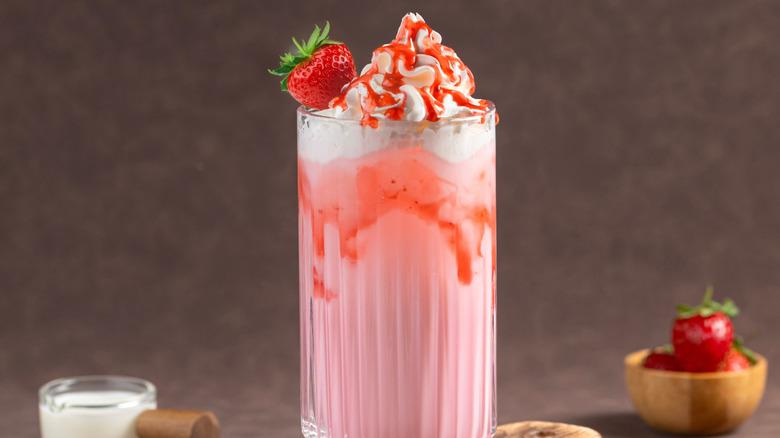strawberry drink in glass with whipped cream