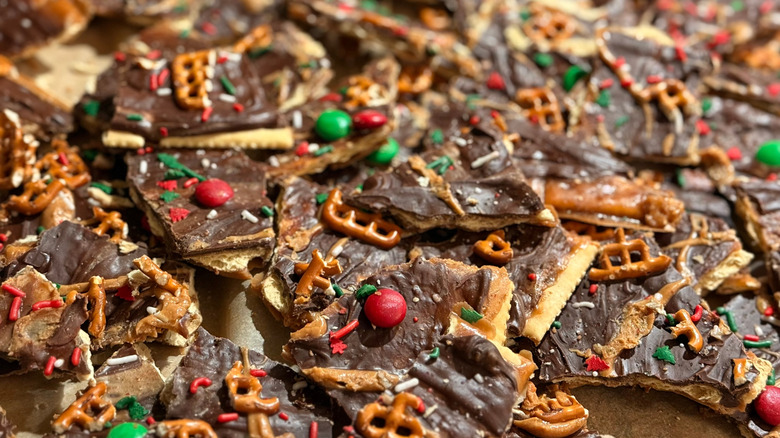 a pile of peanut butter chocolate bark with pretzels and candies