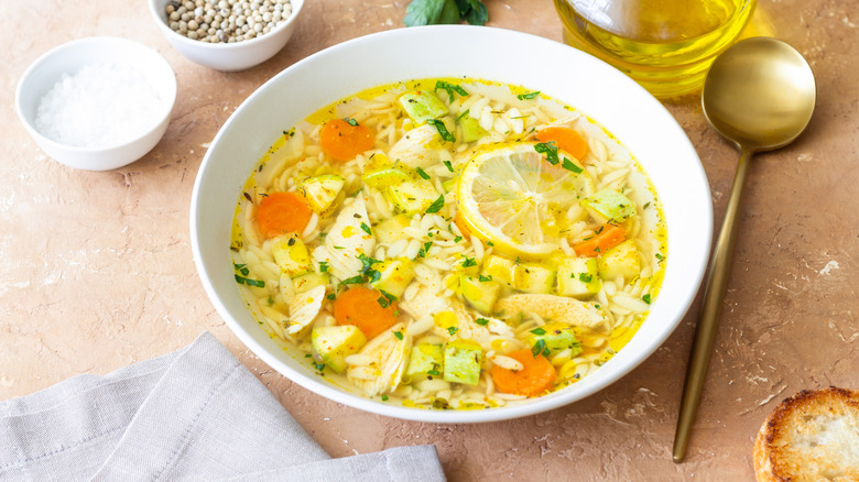 Lemony orzo soup with ingredients.