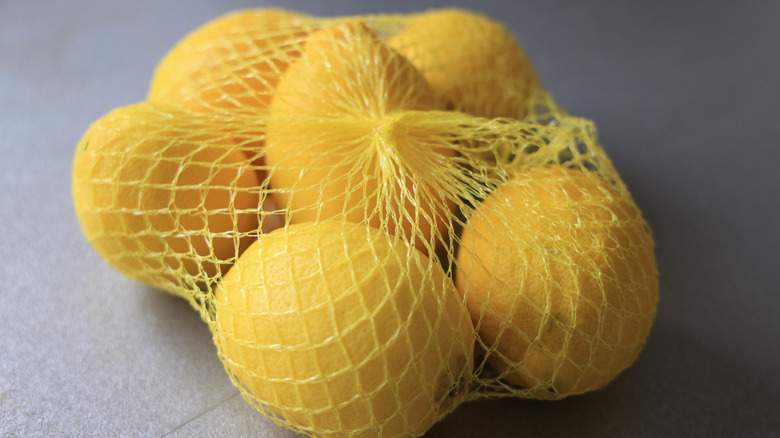 Bag of lemons on a gray background