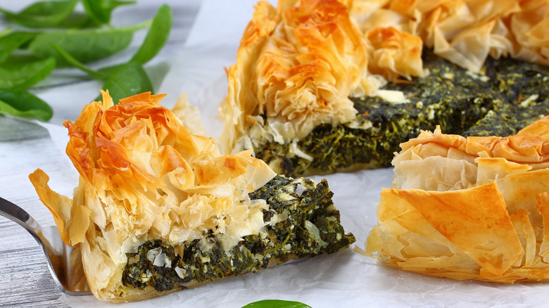 Sliced spanakopita with flaky golden crust.