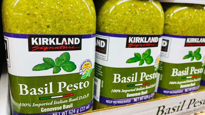 Three jars of Kirkland Signature Basil Pesto lined up in a row