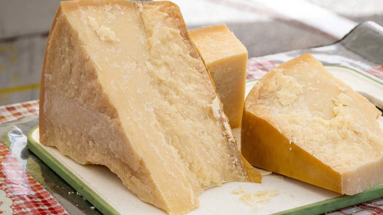 Three blocks of Parmigiano Reggiano of varying sizes
