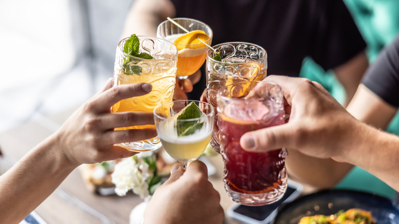 People clinking glasses in a restaurant