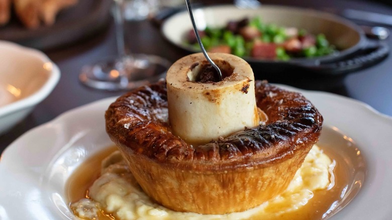 A pot pie from Armitage Alehouse with a marrow bone protruding from the center