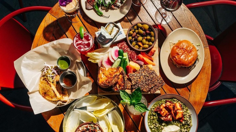 A table covered with Mediterranean dishes and wine from avec in Chicago