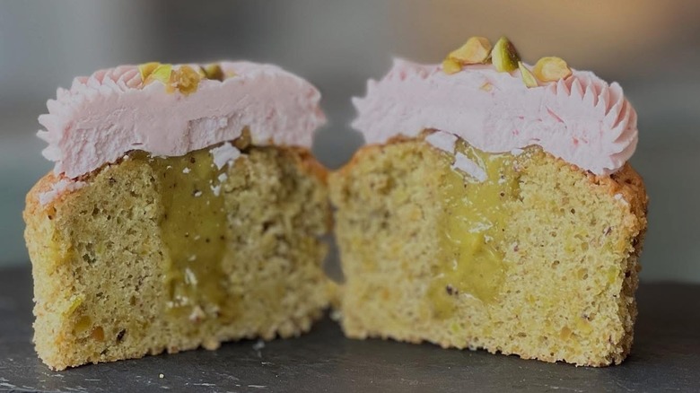 A cupcake crosscut with filling and frosting