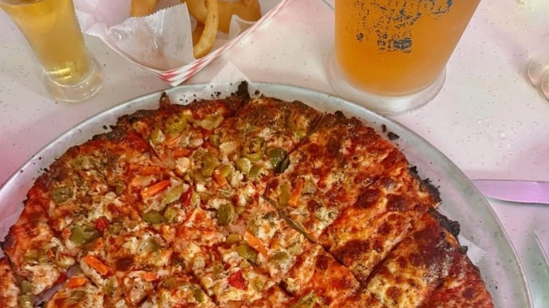 A pizza from Vito & Nick's with onion rings and beer