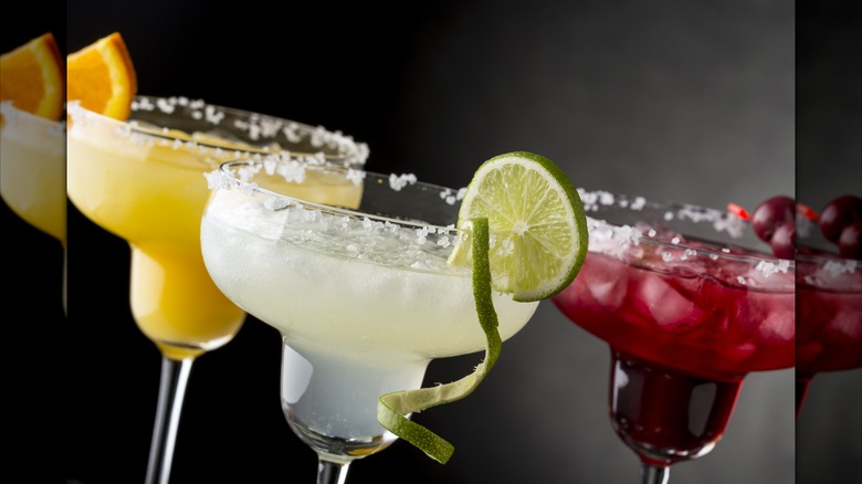 An orange, lime, and cherry margarita side by side