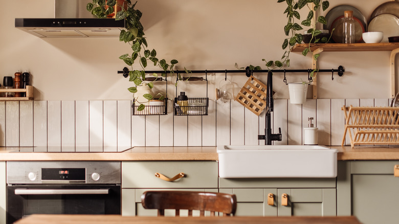 A cozy kitchen with natural light and warm touches of wood and neutral tones.