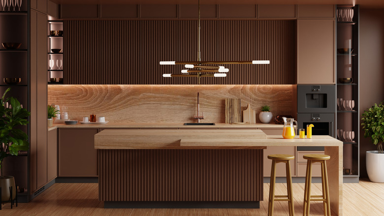 A neutral-toned kitchen with wooden accents and a kitchen island in the center.