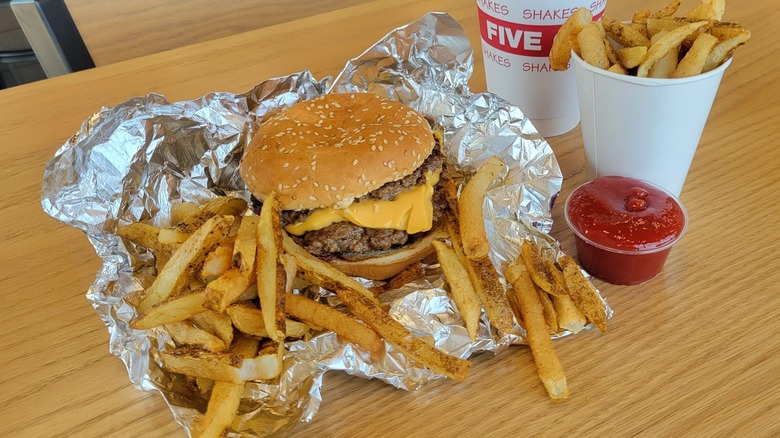 A Five Guys burger and fries with a side of ketchup