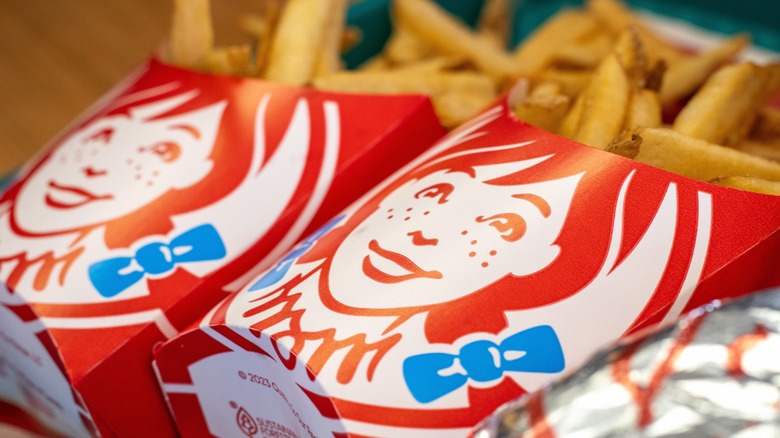 Two cardboard containers of Wendy's fries