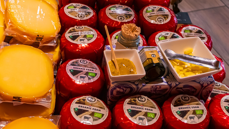 display of edam cheese with toothpicks and mustard