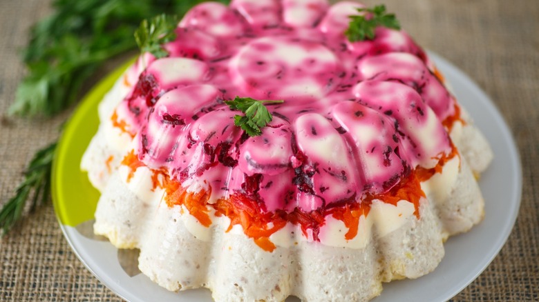 Jell-o salad layered with carrots and other ingredients