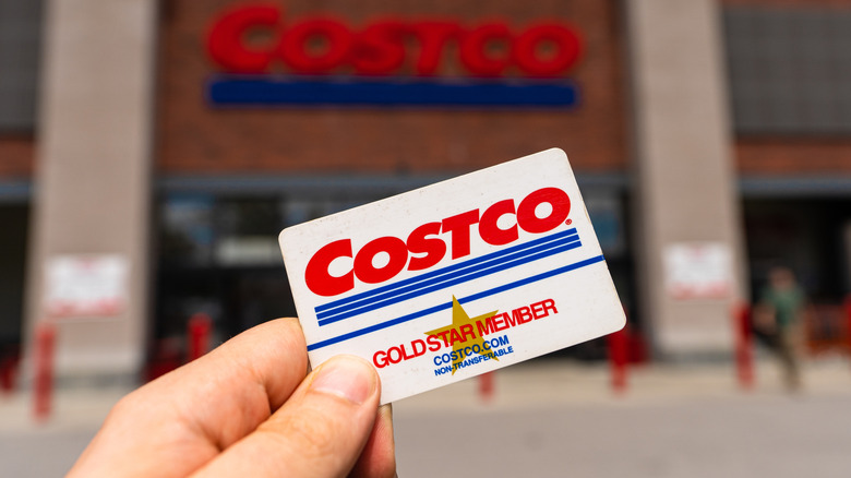 Costco membership card in hand