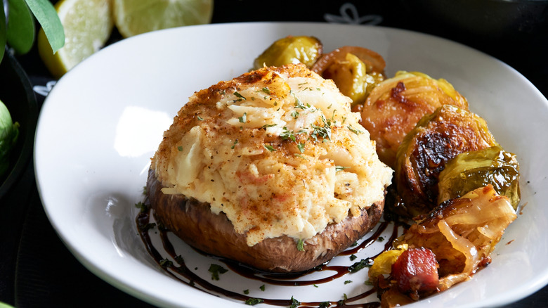 Crab imperial stuffed mushroom served on a white plate