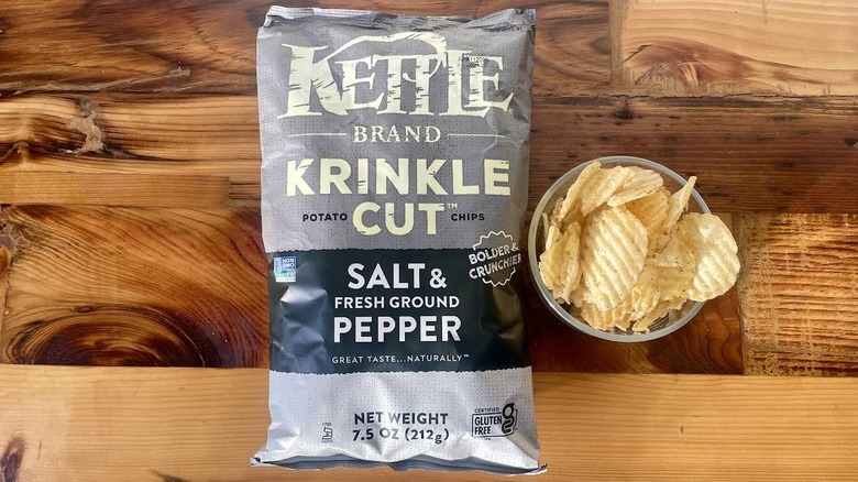 Over head view of a bag and dish of Kettle Brand Krinkle Cut Salt & Fresh Ground Pepper Potato Chips