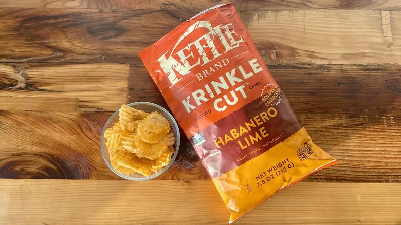 Over head view of a bag and dish of Kettle Brand Krinkle Cut Habanero Lime Potato Chips