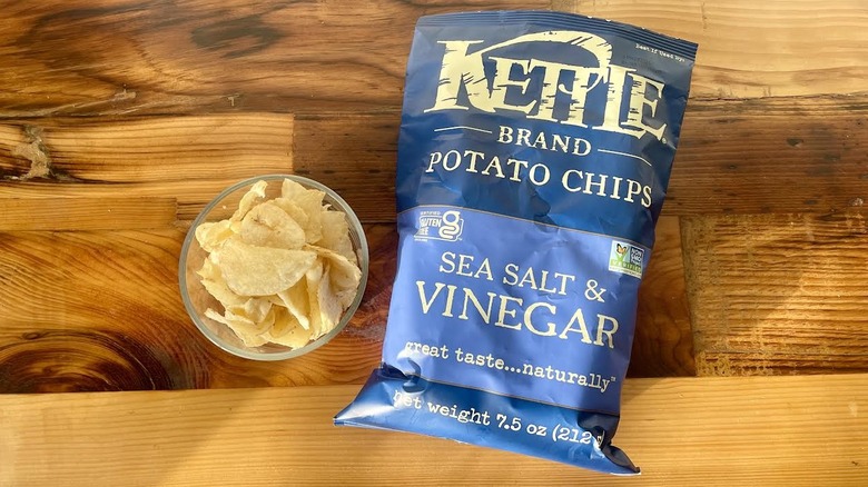 Over head view of a bag and dish of Kettle Brand Sea Salt & Vinegar Potato Chips