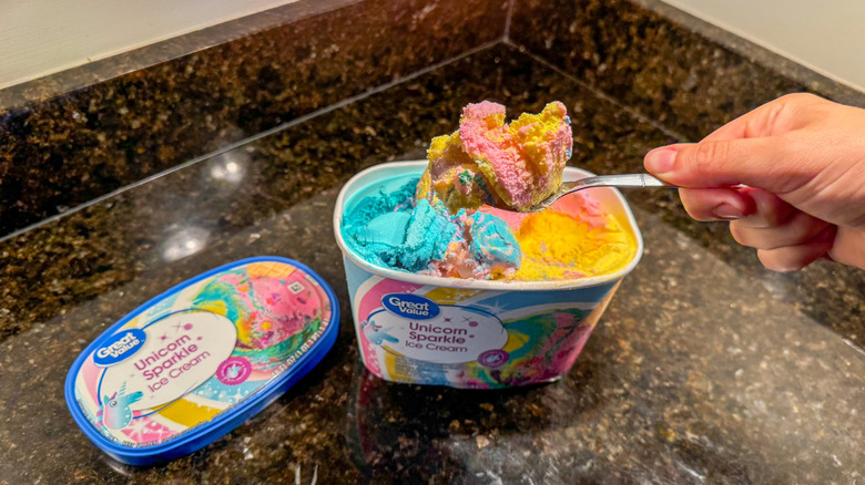 Person scooping Unicorn Sparkle ice cream