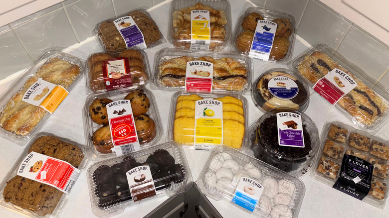 Assorted Aldi baked goods displayed in containers on counter.