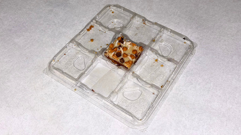 Tray of dessert squares with one left in the middle.