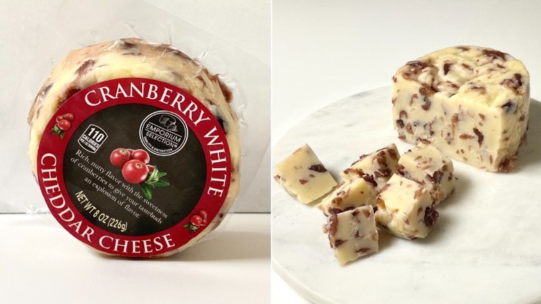 Split image of the Emporium Selection Cranberry White Cheddar Cheese, one packaged and the other cut in a couple cubes on a marble plate