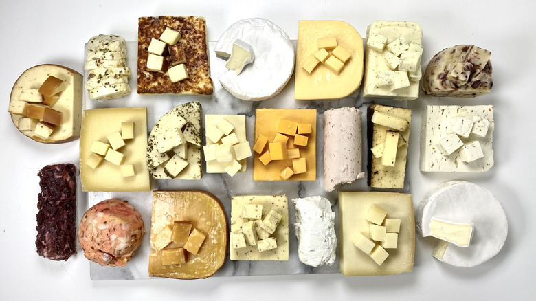Image of assorted Aldi cheeses, cut into serving-size portions on each wedge.