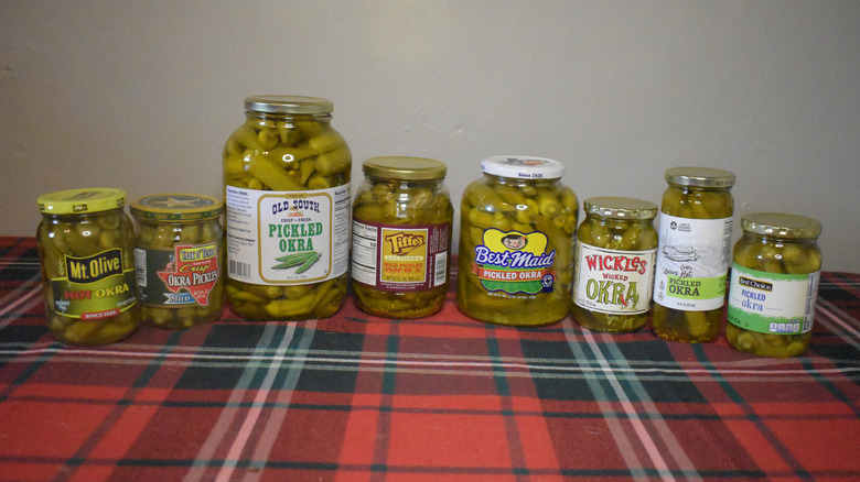 8 jars of pickled okra on a table