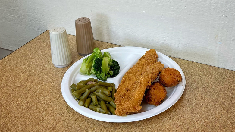 Captain D's Southern-Style Whitefish Meal with salt and pepper shakers on table