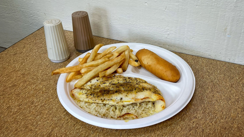 Captain D's Grilled White Fish Meal with salt and pepper shakers on table