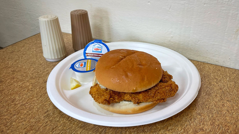 Captain D's Cajun Catfish Sandwich with salt and pepper shakers on table