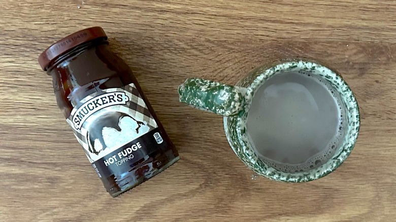 Smucker's Hot Fudge sauce and hot chocolate in a green mug