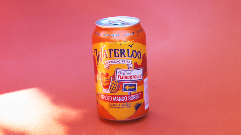 Can of mango sparkling water on backdrop