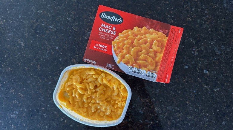 Package and tray of Stouffer's Mac & Cheese on black countertop