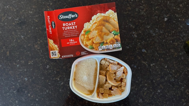 Package and tray of Stouffer's Roast Turkey on black countertop