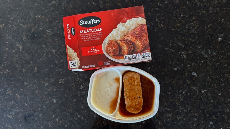 Package and tray of Stouffer's Meatloaf on black countertop