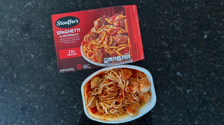 Package and tray of Stouffer's Spaghetti and Meatballs on black countertop