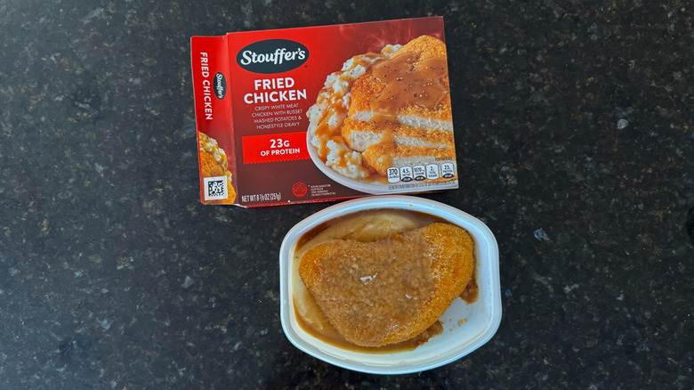 Package and tray of Stouffer's Fried Chicken on black countertop