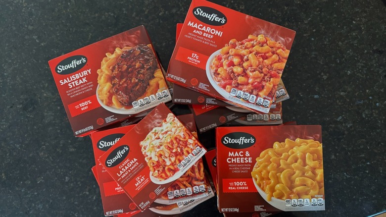 A pile of Stouffer's frozen meals on black countertop