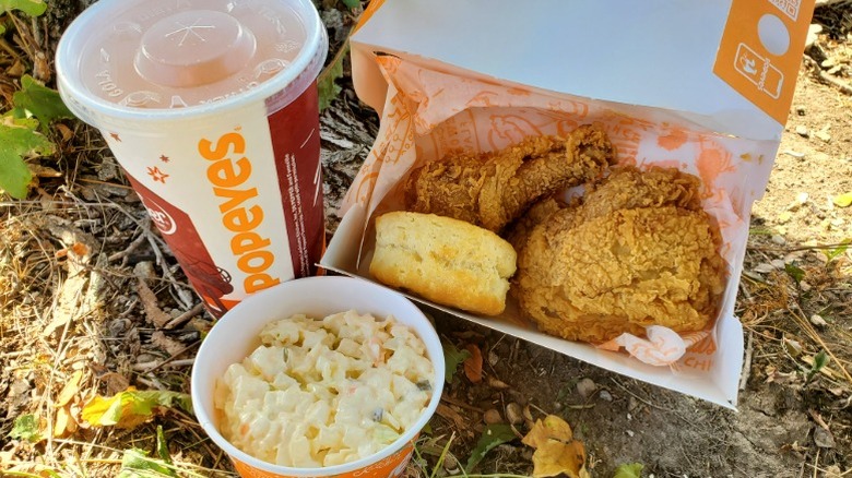 Popeyes fried chicken, biscuit, coleslaw, and fountain beverage