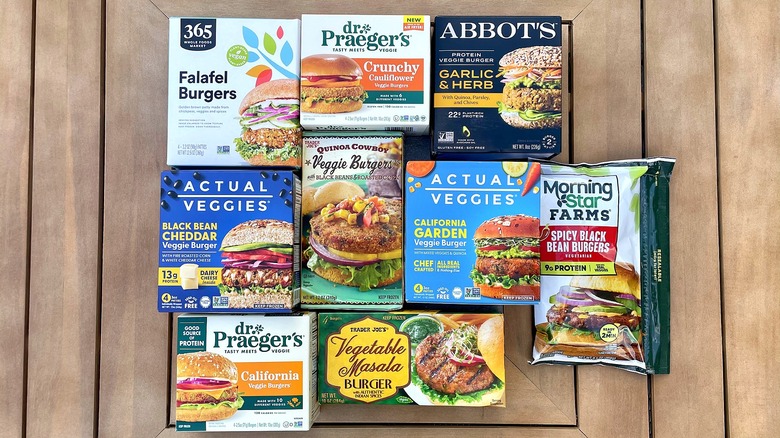 Collection of different frozen veggie burgers in their boxes on a wooden table