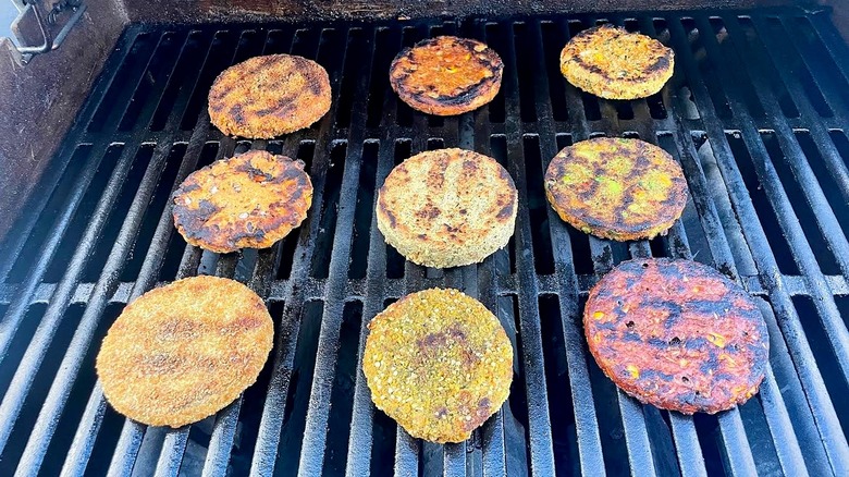A collection of veggie burger patties cooking on a grill