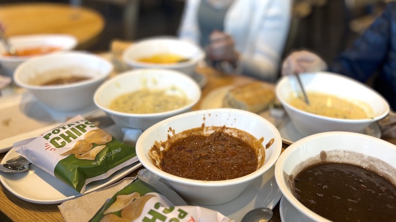 Panera Bread soups spread out on table