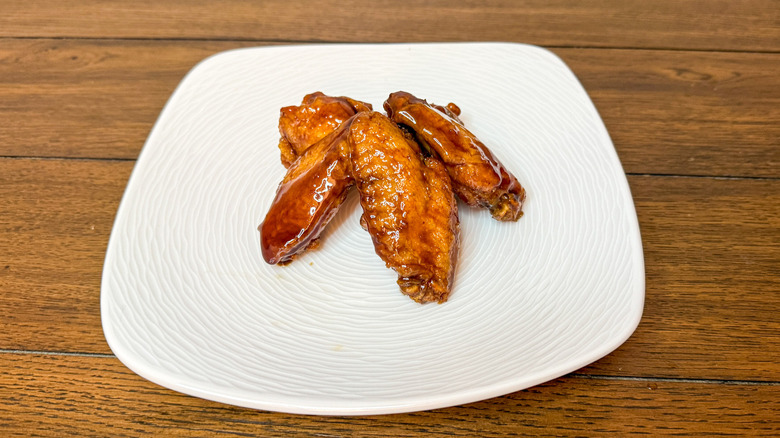 Teriyaki chicken wings on a white plate