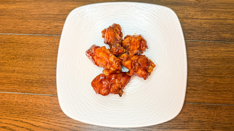 Barbecue chicken wings arranged on a white plate