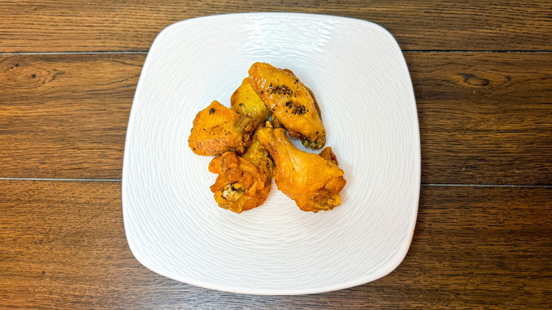 Lemon pepper chicken wings on a white plate