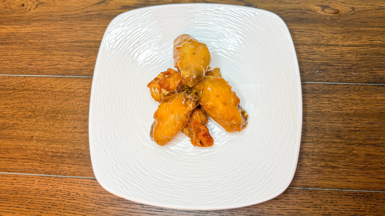 Chicken wings piled on a white plate
