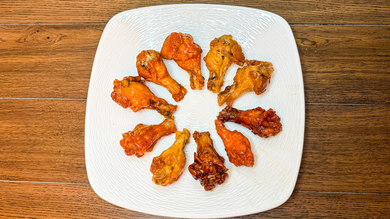 Chicken wings arranged in a circle on a white plate